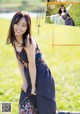 A woman in a long dress posing in a field.