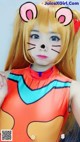 A young girl dressed up as a cat in a costume.